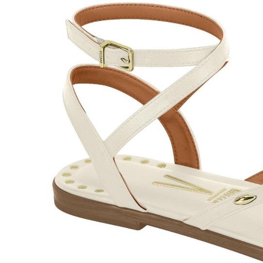 Sandals tied to the leg with golden details that give them an elegant touch